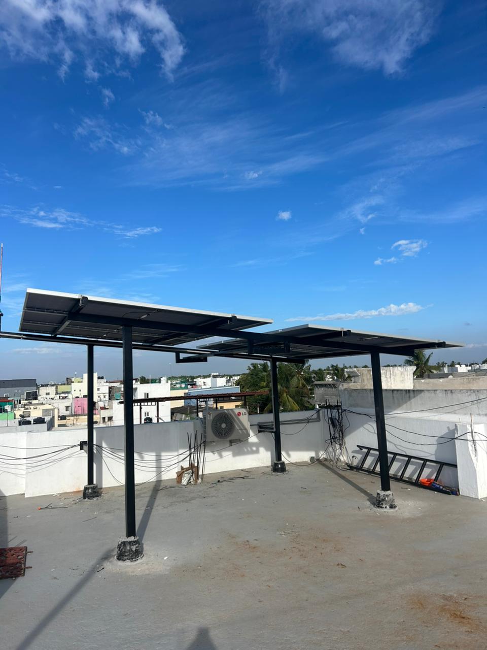 Elevated rooftop solar canopy under a clear blue sky